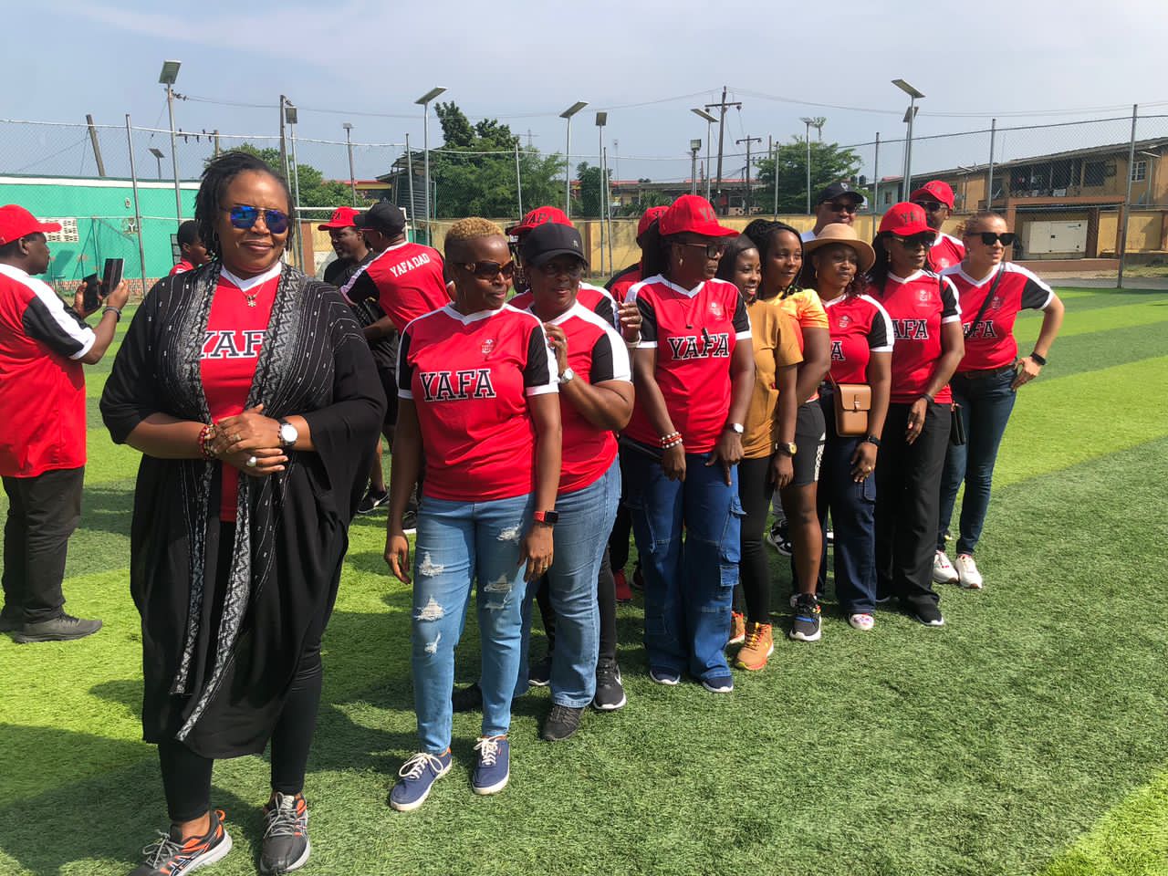 Line-up of YAFA Mums on the turf pitch before a match day