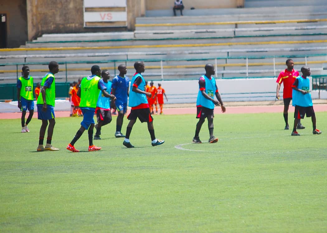YAFA squad and coach in FIFA-NFF TDS bibs before a match at the stadium