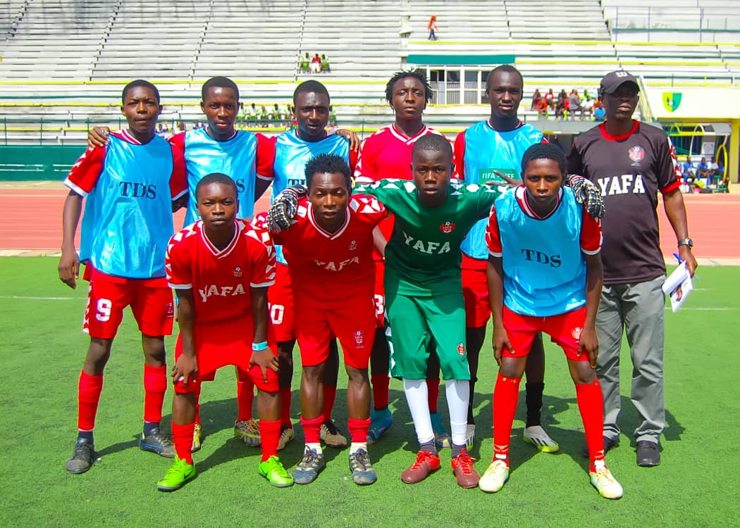 Player shielding the ball in a FIFA-NFF Technical Development Scheme game